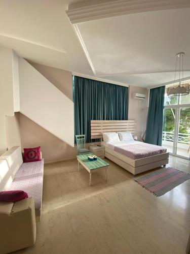 A bed or beds in a room at Saranda Hotel