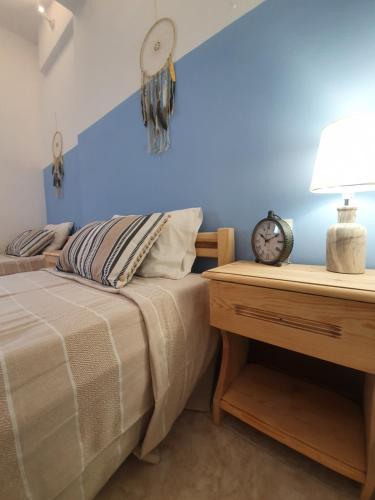 a bedroom with a bed and a nightstand at Irene Family Apartment in Symi
