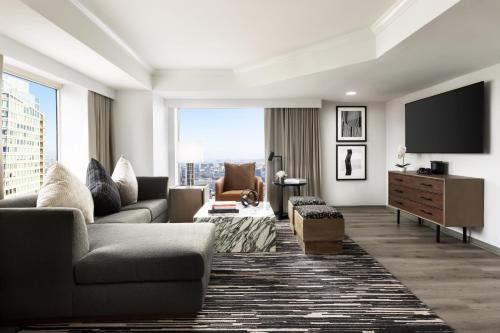 a living room with a couch and a tv at Hyatt Regency San Francisco Downtown SOMA in San Francisco