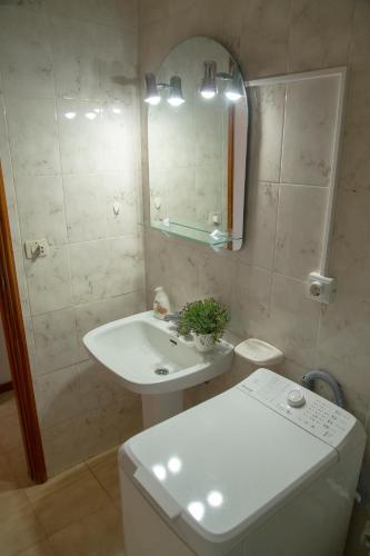 a bathroom with a sink and a mirror and a toilet at Casa Ramón Acosta in Breña Baja