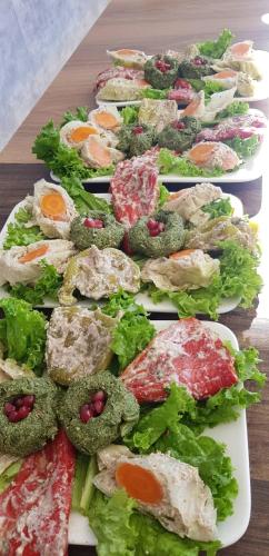 a row of plates of food on a table at Hotel Nobilis Hall in K'obulet'i