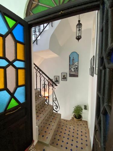 a stairway with a stained glass window and stairs at Dar Tinjâa in Tangier