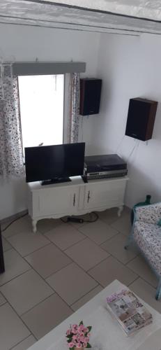 a living room with a bed and a window at LA P'TITE MAISON in Charleroi