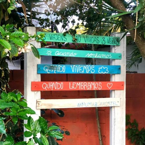 a sign with many different languages on it at Numa Boa HOSTEL Búzios in Búzios