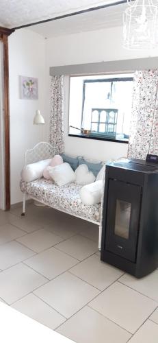 a room with a couch with a television in it at LA P'TITE MAISON in Charleroi