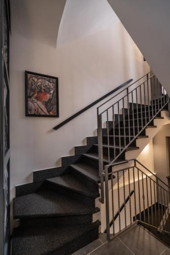 a staircase in a house with a painting on the wall at Relais Manzoni in Rome