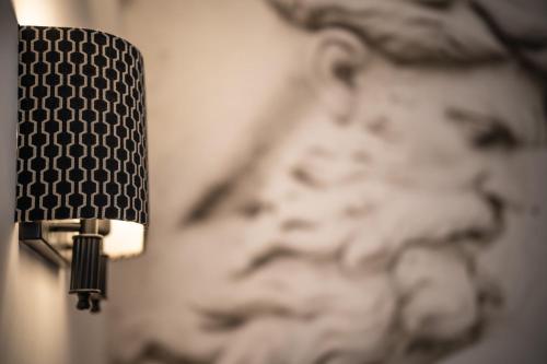 a close up of a light on a wall at Relais Manzoni in Rome