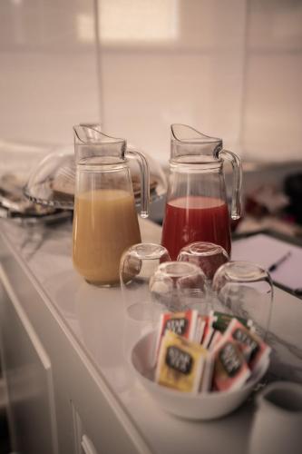 a kitchen counter with two jars and a plate of food at Relais Manzoni in Rome