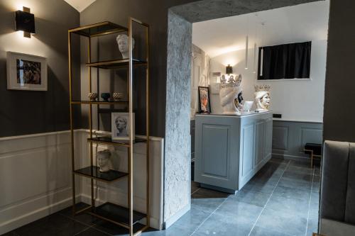 a room with a shelf with photographs on it at Relais Manzoni in Rome