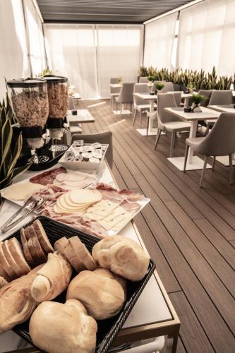 a room with a table with bread and other foods at Relais Manzoni in Rome