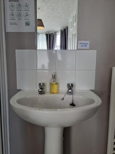 a white sink in a bathroom with a mirror at The Cameo in Blackpool