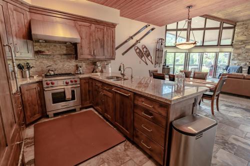 a kitchen with wooden cabinets and a stove top oven at Powder Run 2 Bedroom and loft by Park City Vacations in Park City