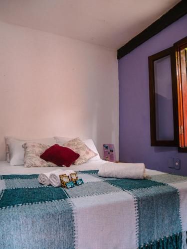 a bedroom with a bed with two towels on it at Numa Boa HOSTEL Búzios in Búzios