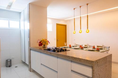 a kitchen with a counter and a stove top oven at Solar Porto Rico in Porto De Galinhas