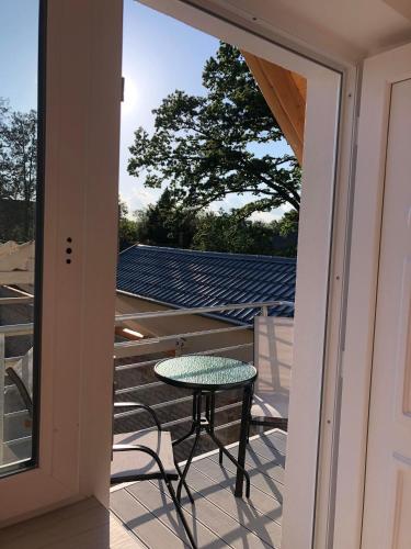 a glass door leading to a patio with a table at Fazekas Vendégház in Balatonkeresztúr