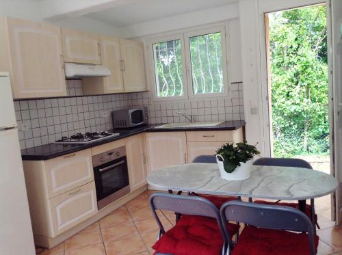 une cuisine avec une table, des chaises, une table et une table dans l'établissement Charmant appartement à Le Muy avec terrasse et jardin, au Muy