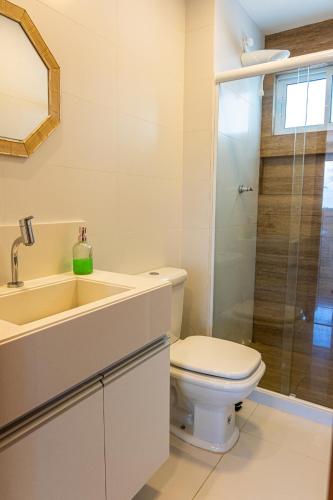 a bathroom with a toilet and a sink and a shower at Solar Porto Rico in Porto De Galinhas