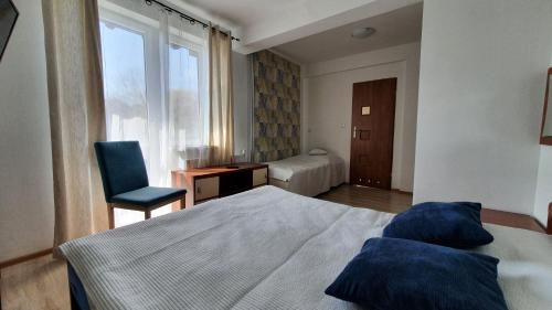 Un pat sau paturi într-o cameră la Bryza Międzyzdroje