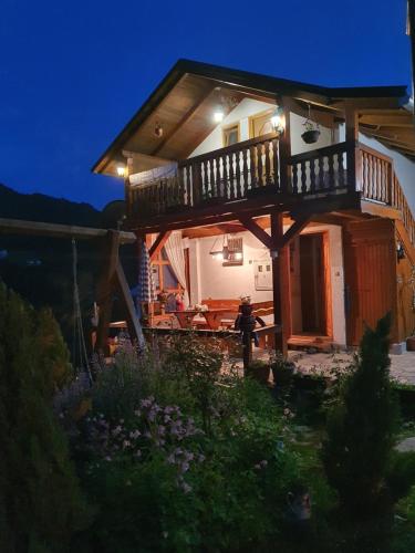 a house with a balcony on top of it at night at Privatni smještaj Kurtalija in Jajce