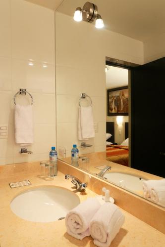 a bathroom with a sink and a large mirror at Casa Suyay in Lima
