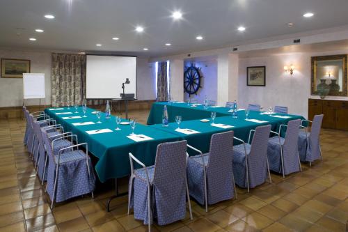 a meeting room with a long table and chairs at Parador de Ribadeo in Ribadeo