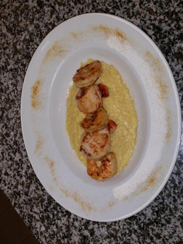 a plate of food with shrimp on top of eggs at Auberge des toqués in Pégomas