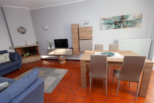 a living room with a blue couch and a table at Casa di Dario in Diano dʼAlba