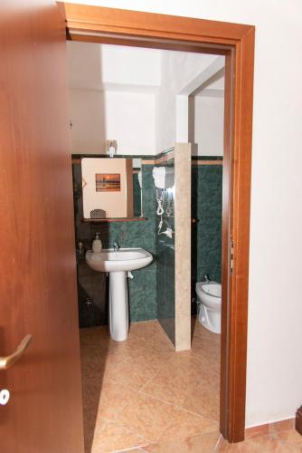 a bathroom with a sink and a toilet at Baglio Mustazza in Buseto Palizzolo