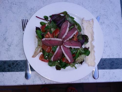 a plate of food with a salad on a table at Auberge des toqués in Pégomas