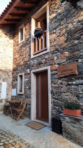 a stone building with a door and a window at Apimonte O Cantinho da Maria - PN Montesinho in Bragança