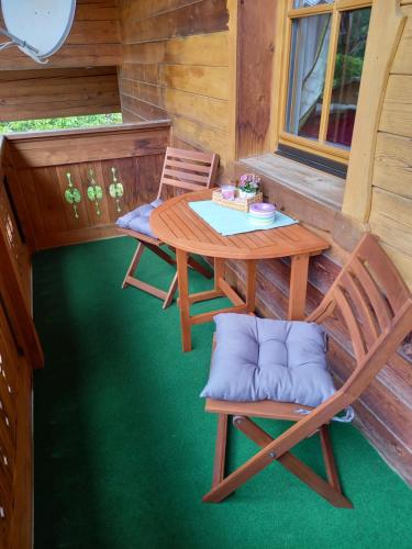 a patio with a table and chairs on a porch at Nagelehof 3 in Ainet