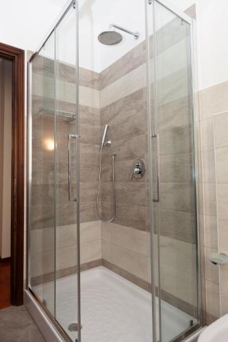 a shower stall with a glass door in a bathroom at Casa di Dario in Diano dʼAlba