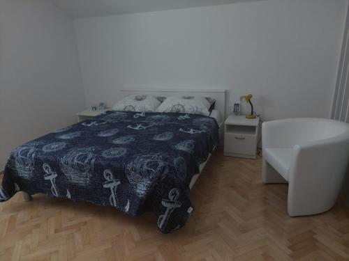 a bedroom with a bed and a white table at Apartments "Jope i Toni" in Biograd na Moru