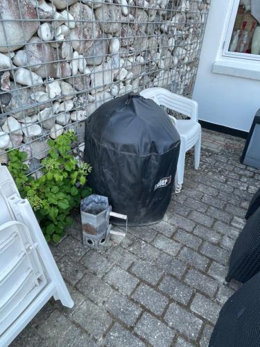 a black cover sitting in front of a building at Sleep In Brande - Close By Herning, Legoland, Givskud Zoo in Brande