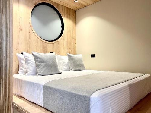 a bedroom with a large bed with a mirror on the wall at beminimal Hotel in Medellín