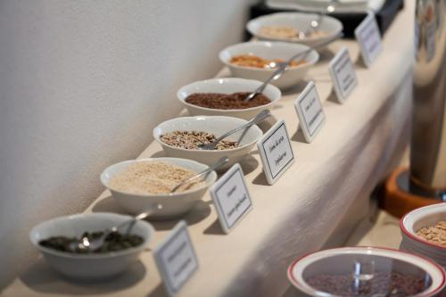 a row of bowls of food on a shelf at Sporthotel Villa Stella in Nago-Torbole