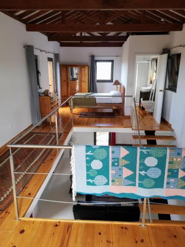 a room with a bunk bed and a room with a bed at Retiro dos Bons Sinais in São Roque do Pico
