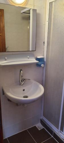 a bathroom with a sink and a mirror at Grand Yayla Hotel in Cesme