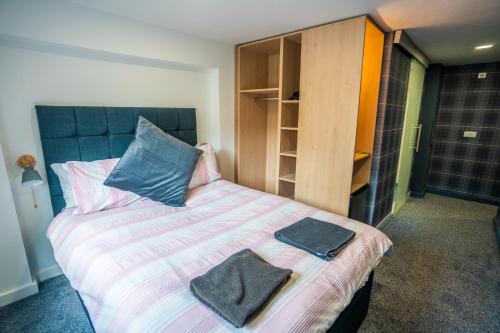 a bedroom with a bed with two towels on it at Apartment Chinatown 302 in Newcastle upon Tyne