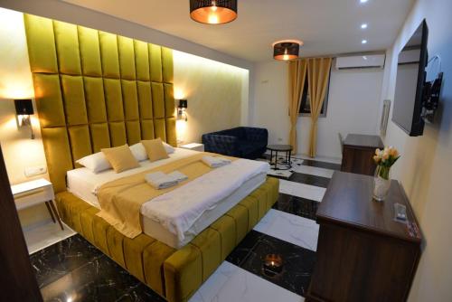 a hotel room with a large bed and a desk at Prenoćište Bis in Prijepolje