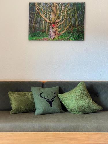a painting of a deer on the wall above a couch at Landgasthof Jostalstüble in Titisee-Neustadt
