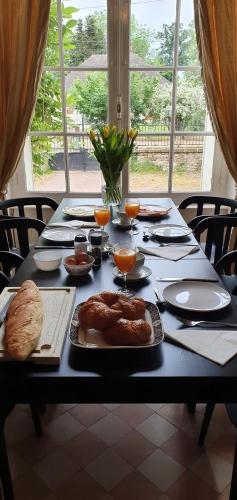 a black table with food on top of it at Maison de la Comtesse in Cosne-dʼAllier