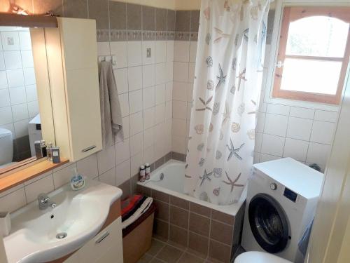 a bathroom with a tub and a sink and a shower curtain at TWO SEAS in Stavros