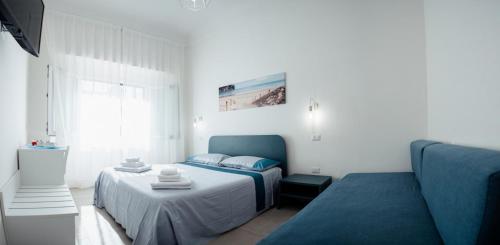 a bedroom with a bed and a couch at Torre del Salento in Torre San Giovanni Ugento