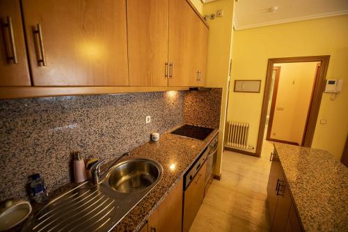 a kitchen with a sink and a counter top at Samil Apartment, primera línea de playa con Wifi y Garaje in Vigo