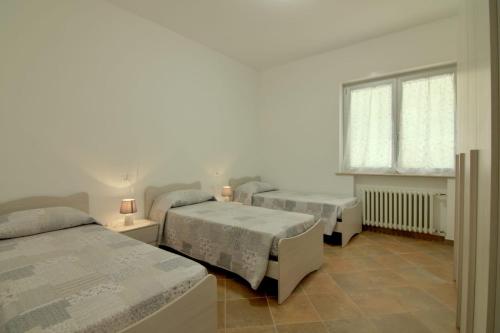 Ένα ή περισσότερα κρεβάτια σε δωμάτιο στο Palazzina Romani-Romani Holidays Apartments