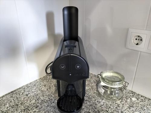 a black blender on a counter next to a glass bowl at Casa da Alfândega em Vila do Conde in Vila do Conde