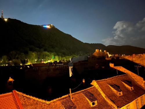 a view of a city at night with a mountain at KronSoul in Braşov