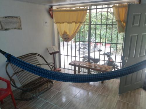 a room with a hammock in front of a door at APARTA-Refugio El Retiro Verde in Leticia