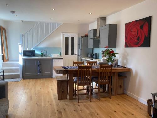 a kitchen and dining room with a table and chairs at Coach house Harrogate in Harrogate
